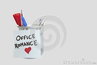 Conceptual image of sticky notepaper with heart shape depicting office romance Stock Photo