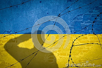 Conceptual image of war between Russia and Ukraine with shadow of soldier against wall with flags Stock Photo