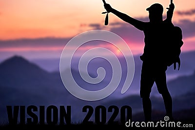 Conceptual message writing showing `vision 2020`. The young mountaineer managed to climb to the top and achieve his goal. Stock Photo