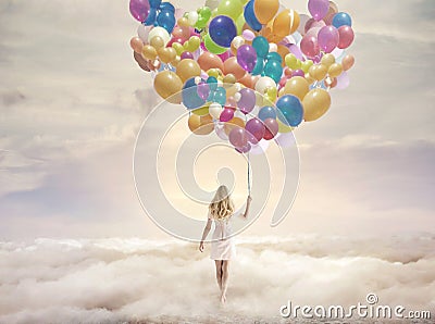 Conceptual picture of a woman holding hundreds of balloons Stock Photo