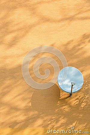 Conceptual satellite on orange wall Stock Photo