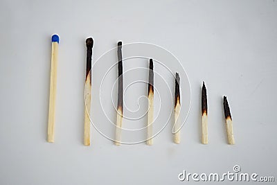 Conceptual set of burnt matches gradually arranged by stages of their incineration Stock Photo