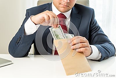 Conceptual shot of bribed politician taking envelope with money Stock Photo