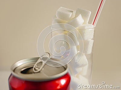 Conceptual still life image of glass with straw full sugar cubes and soda refresh drink in unhealthy nutrition sugar addiction an Stock Photo