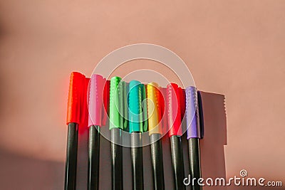 Conceptual still life of vibrant colored pens in a row Stock Photo