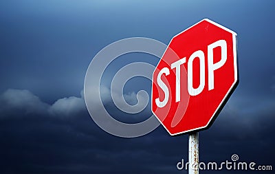 Conceptual stop sign with stormy clouds background. Stock Photo