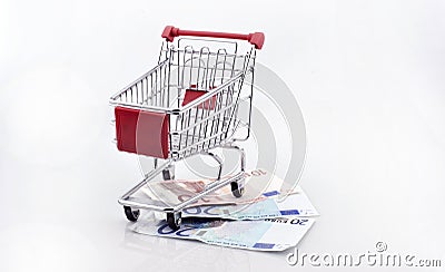 Conceptual studio shot of a bunch of euro banknotes filling a shopping cart on white background september 18, 2016 Stock Photo