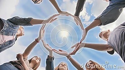 Conceptual symbol of cooperation diverse hands making a circle. Students help each other. Stock Photo