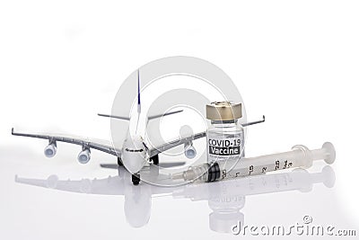 Conceptual travel restriction with coronavirus vaccine vial, syringe and model passenger airplane Stock Photo
