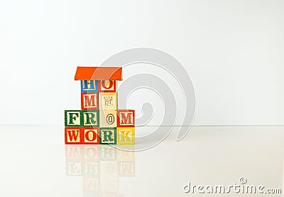 Conceptual of work from home during lockdown directives during virus outbreak. Wooden alphabet cubes forming WORKFROMHOME. Focus Stock Photo