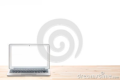 Conceptual workspace or business concept. Laptop computer with blank white screen on light wooden table. Isolated background. Stock Photo