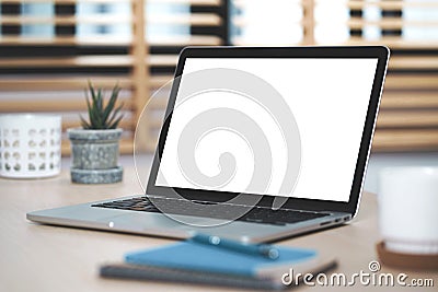 Conceptual workspace, Laptop computer with blank white screen on table. Stock Photo