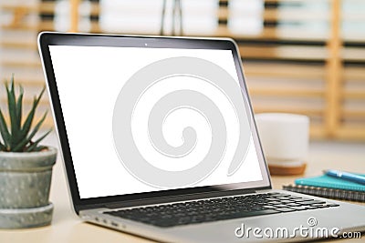 Conceptual workspace, Laptop computer with blank white screen on table. Stock Photo
