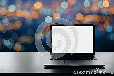 Conceptual workspace, Laptop computer with blank white screen on table, blurred background. Stock Photo