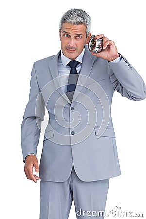 Concerned businessman with alarm clock Stock Photo