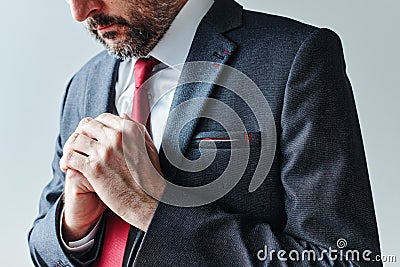 Concerned businessman with folded hands Stock Photo