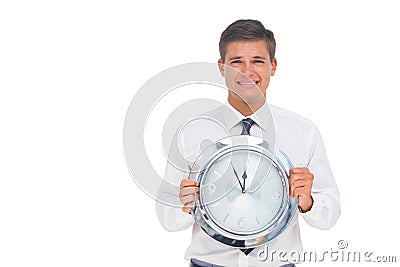 Concerned businessman holding clock Stock Photo