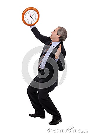 Concerned businessman looking at a clock Stock Photo