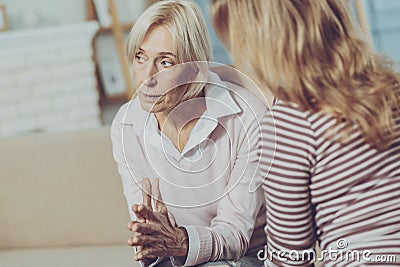 Concerned elderly woman looking into the distance Stock Photo