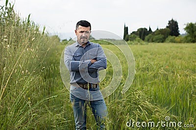 Concerned mature man among green grass Stock Photo