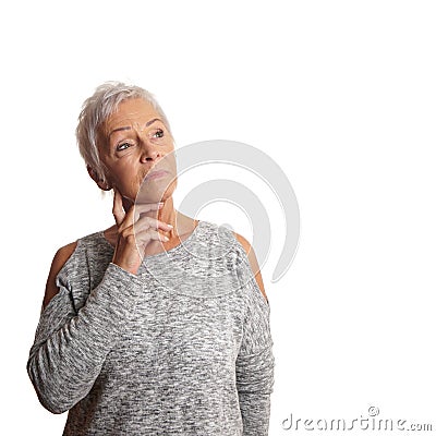 Concerned mature woman looking up Stock Photo