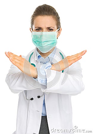 Medical doctor woman in mask showing stop gesture Stock Photo