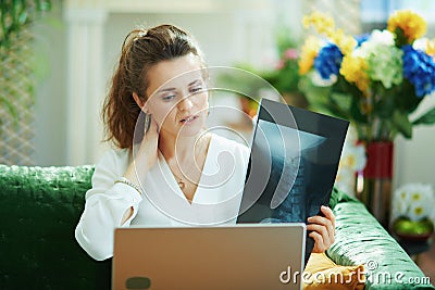 Concerned modern female with x-ray speaking with doctor Stock Photo