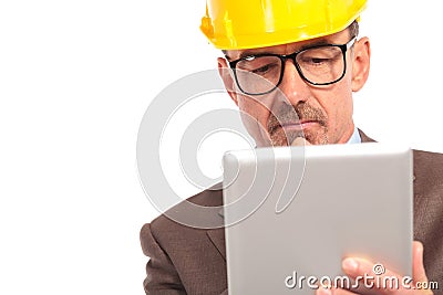 Concerned senior construction engineer reading on his tablet Stock Photo