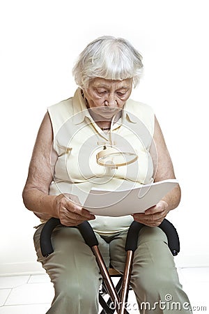 Concerned senior reading letter Stock Photo