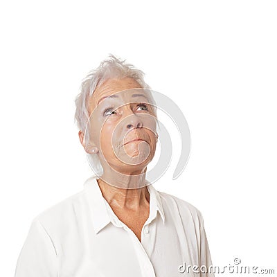 Concerned senior woman looking up Stock Photo