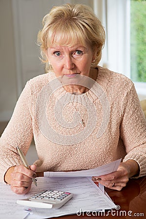 Concerned Senior Woman Reviewing Domestic Finances Stock Photo