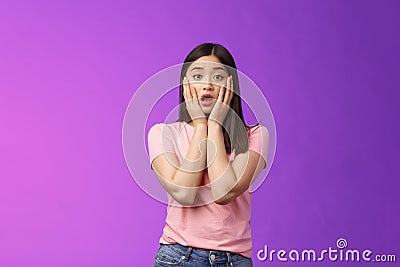 Concerned shocked timid insecure asian woman, feel pitty, shame hearing shocking news, grab face sorry for friend Stock Photo