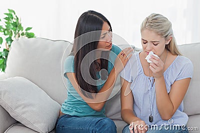 Concerned woman comforting her crying friend Stock Photo