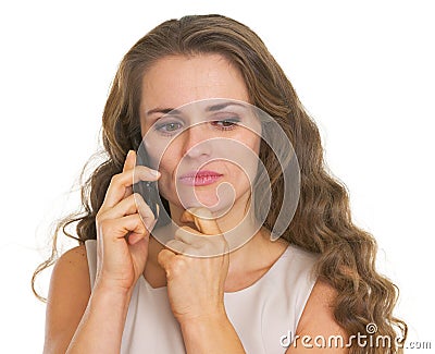 Concerned young woman talking cell phone Stock Photo