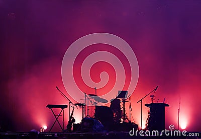 Concert stage on rock festival, music instruments silhouettes, drums and microphones Stock Photo