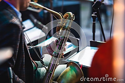 Concert view of a saxophonist, saxophone player with vocalist and musical during jazz orchestra performing music on stage Stock Photo