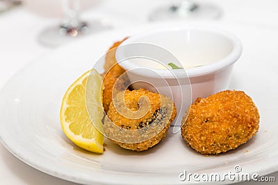 Conch Fritters with Lemon and Sauce Stock Photo