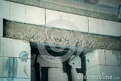 Concrete armored belt above the doorway in the wall of white aerated concrete bricks. Blocked doorway bricked up Stock Photo