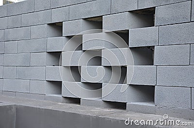 a concrete block fence encloses the yard. a robbing Stock Photo