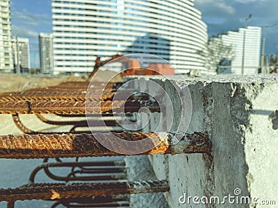 Concrete block with rusty rebar sticking out inside. fasteners for the construction of concrete high houses. blocks on the Stock Photo