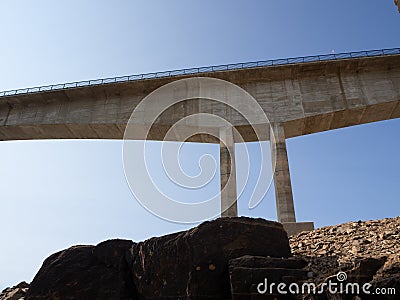 Concrete bridge under construction over a reservoir Stock Photo