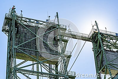 Concrete counterweights on truss towers of a metal drawbridge in sunlight Stock Photo