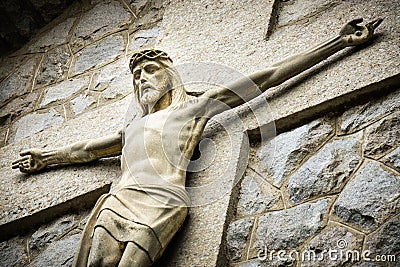 Concrete Crucifix of Jesus Christ on the wall of the Catholic Church, Croatia Stock Photo