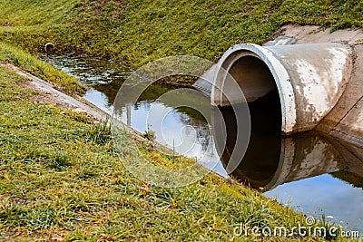 Concrete culvert pipe hole system draining sewage water. Environ Stock Photo