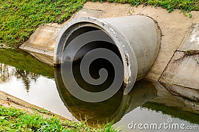 Concrete culvert pipe hole system draining sewage water. Environ Stock Photo