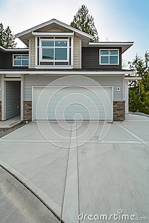 Concrete driveway of brand new residential triplex house Stock Photo