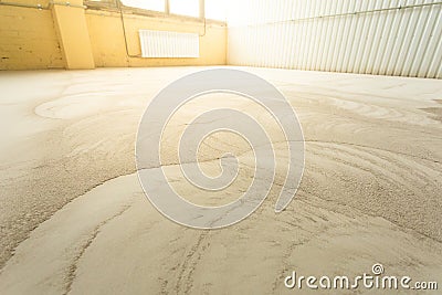 Concrete floor grinding. Construction process. Sanding a concrete floor with a sander in a warehouse Stock Photo