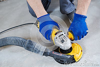 Concrete floor surface grinding by angle grinder machine Stock Photo
