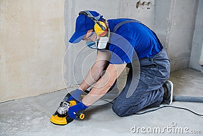 Concrete floor surface grinding by angle grinder machine Stock Photo