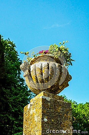 Concrete flower pots in the garden on a pedestal stylized antique, a place of rest, practical urban Stock Photo